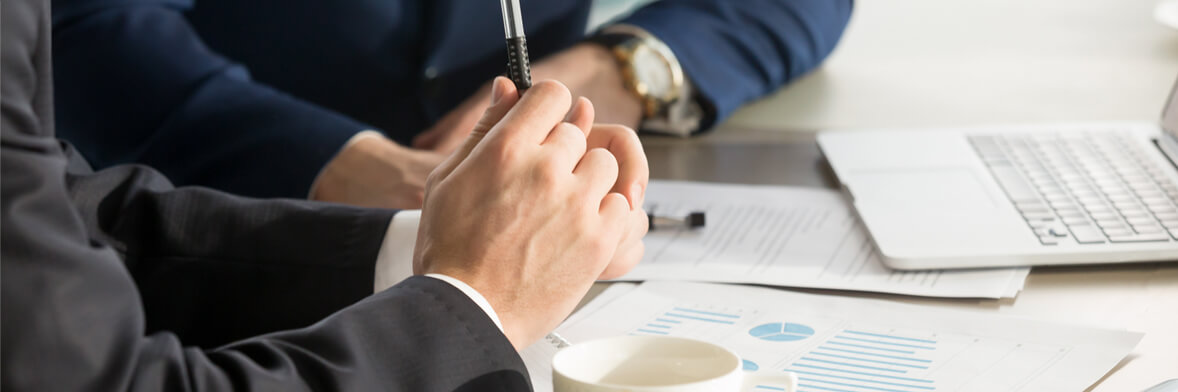 header of a mans hands closed together while in a meeting