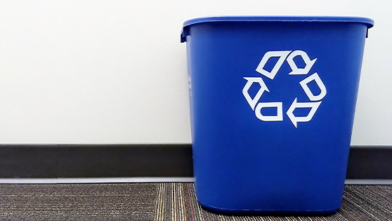 blue trash can with recycle logo on it